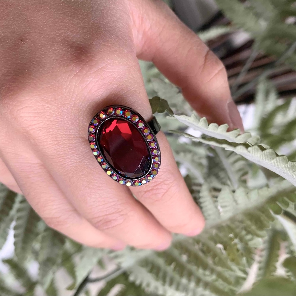 Oval Ruby ring surrounded by small zircons